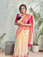 Off-White Mul Cotton Saree with medium sized pink and gold kanchi style border.