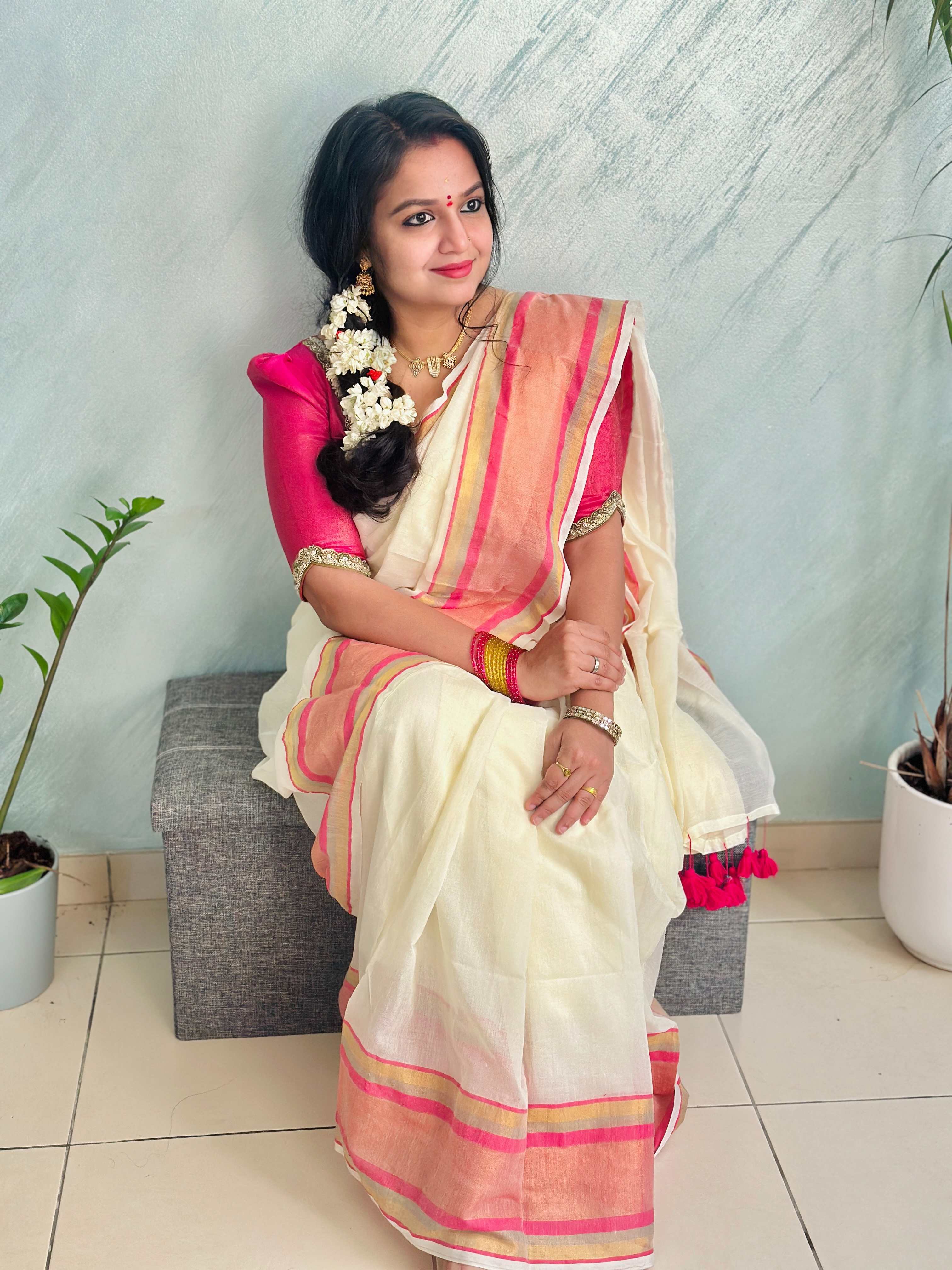 Off-White Mul Cotton Saree with medium sized pink and gold kanchi style border.